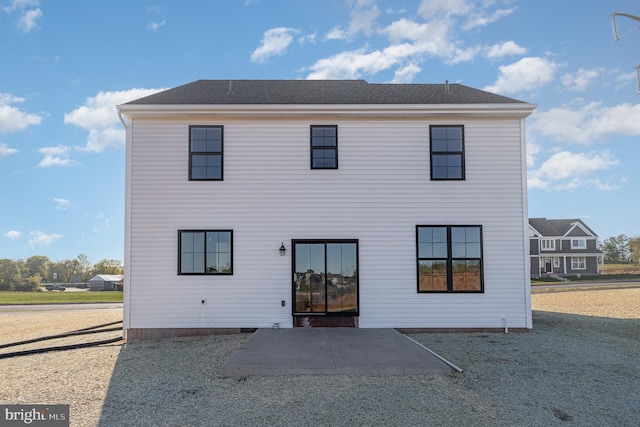 back of property with a patio