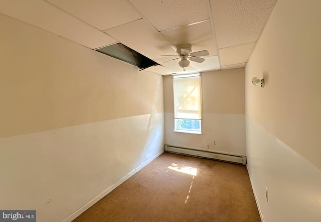 additional living space featuring ceiling fan, carpet flooring, and a baseboard heating unit