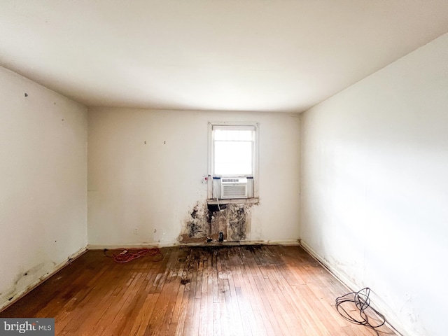 spare room with wood-type flooring and cooling unit