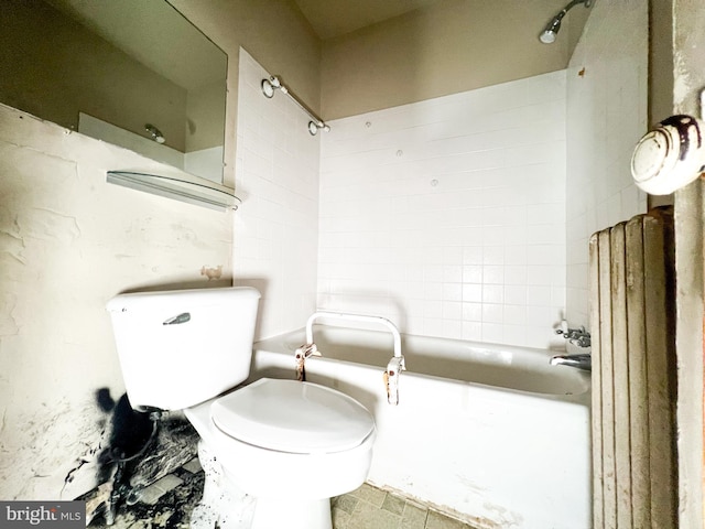 bathroom featuring toilet and tiled shower / bath combo