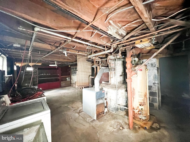 basement with water heater and washer and clothes dryer