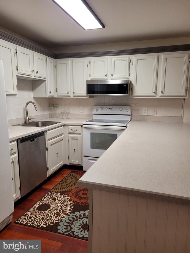 kitchen featuring white cabinetry, stainless steel appliances, dark hardwood / wood-style flooring, and sink