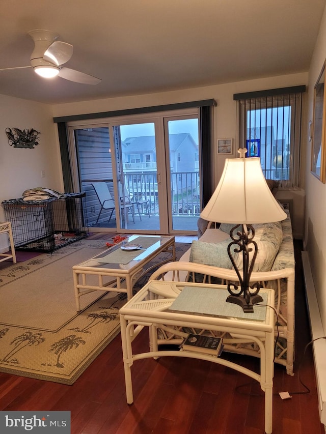 living room with wood-type flooring and ceiling fan