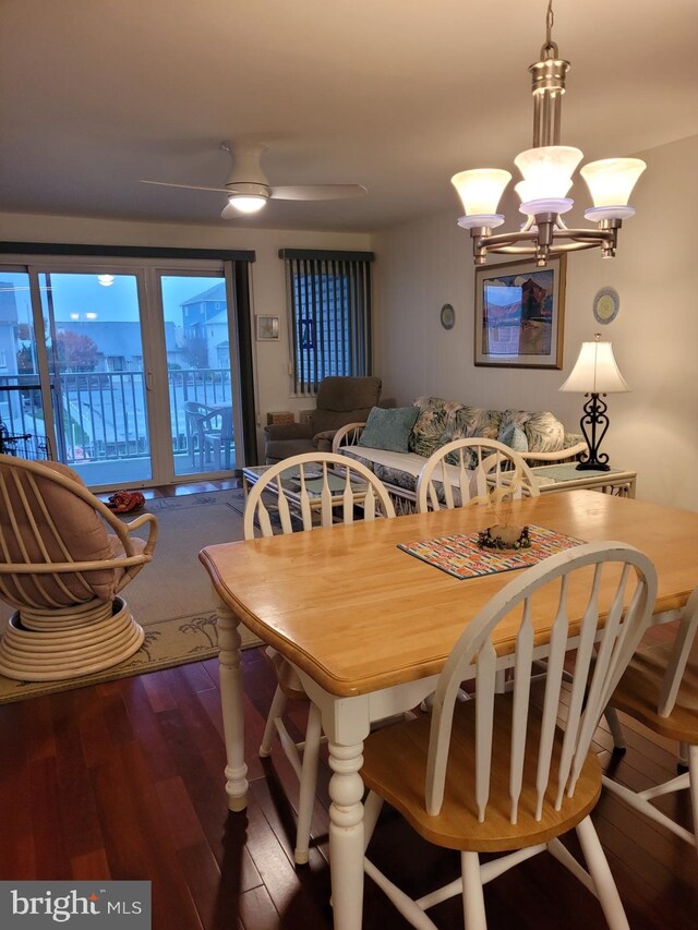 dining room featuring ceiling fan with notable chandelier and hardwood / wood-style flooring