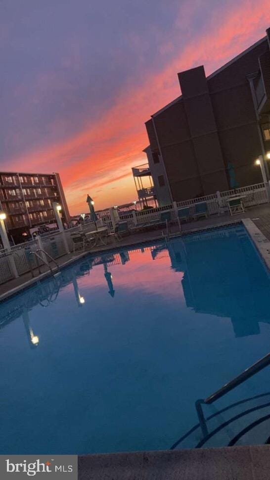 view of pool at dusk