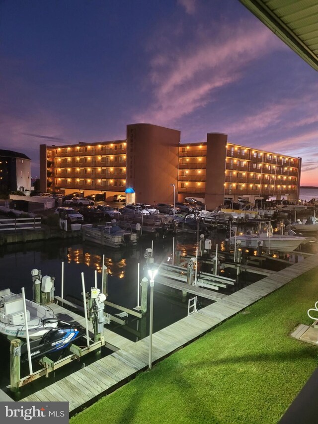 view of dock with a lawn