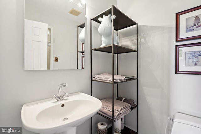 bathroom featuring visible vents and a sink