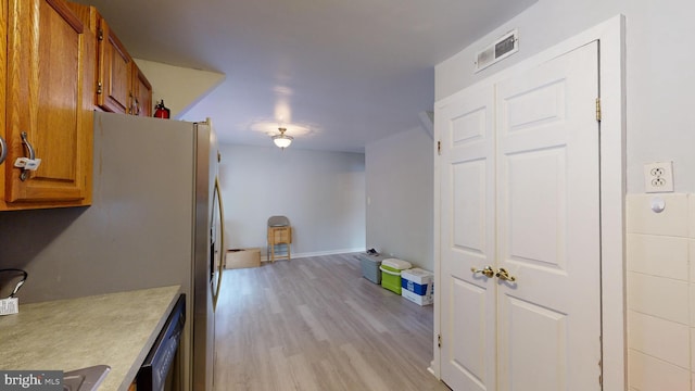 kitchen featuring light hardwood / wood-style flooring and stainless steel refrigerator