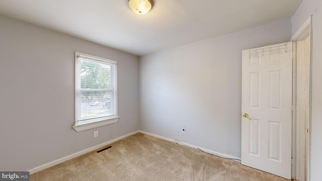 empty room with light colored carpet