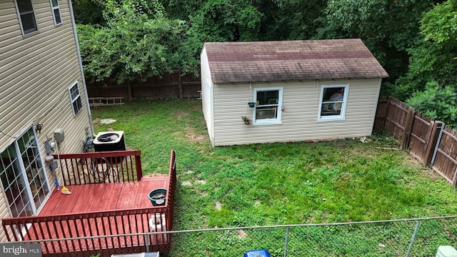 exterior space with a storage unit, central AC unit, and a yard