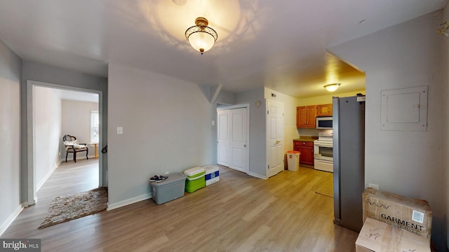 interior space with light wood-type flooring and electric panel