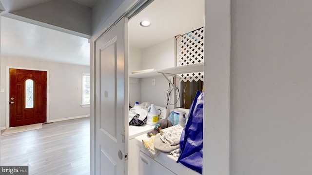 washroom with light wood-type flooring and washer and clothes dryer