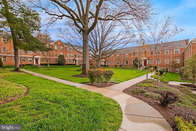 view of property's community with a lawn