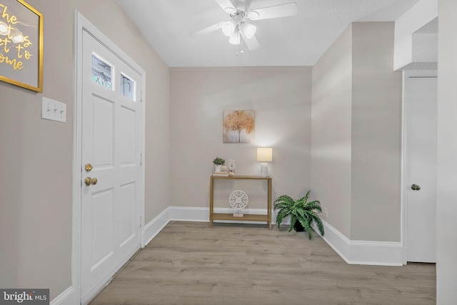 entrance foyer with ceiling fan, light hardwood / wood-style flooring, and a textured ceiling