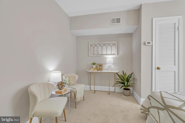 living area featuring light colored carpet