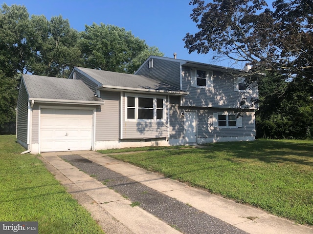 split level home with a garage and a front yard