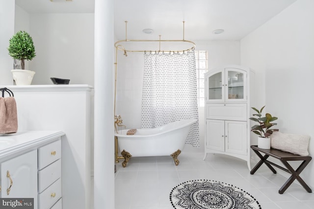 bathroom with tile patterned flooring, shower with separate bathtub, and vanity