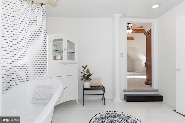 bathroom featuring tile patterned floors, decorative columns, a tub, and ceiling fan