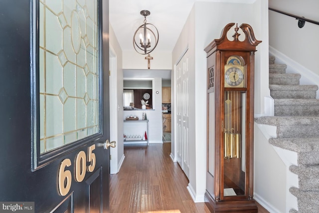 entrance foyer featuring wood-type flooring and a notable chandelier