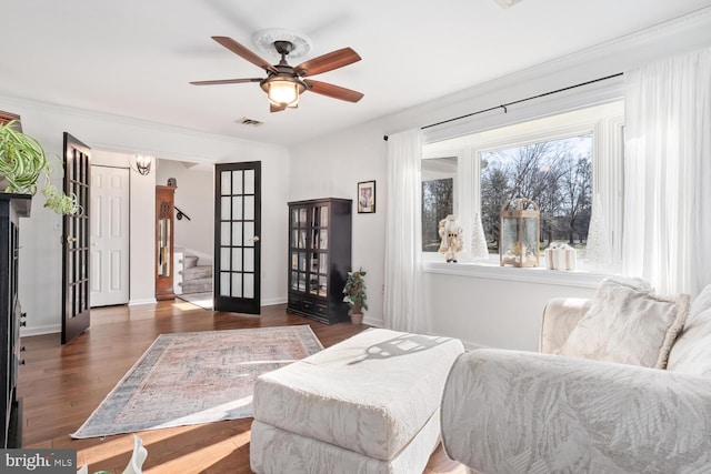 living area with ceiling fan and dark hardwood / wood-style flooring