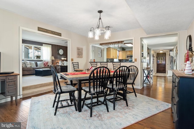 dining area featuring dark hardwood / wood-style floors and a notable chandelier