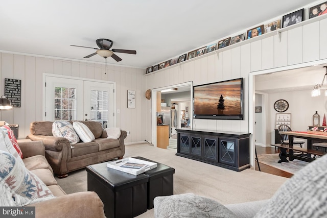 carpeted living room featuring french doors and ceiling fan