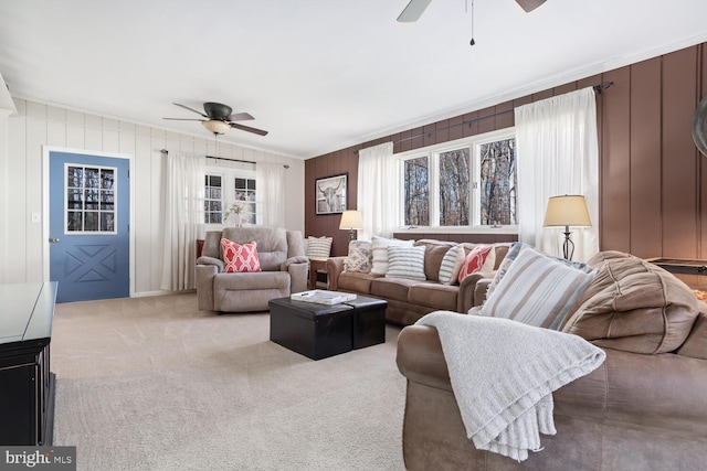 living room with ceiling fan, plenty of natural light, and carpet flooring