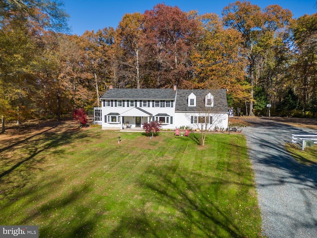 cape cod house with a front lawn and a porch