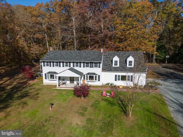 view of front of house with a porch and a front yard