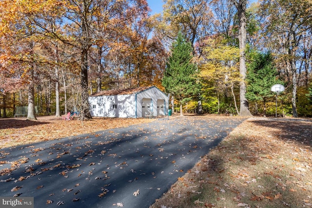 exterior space with a garage and an outdoor structure