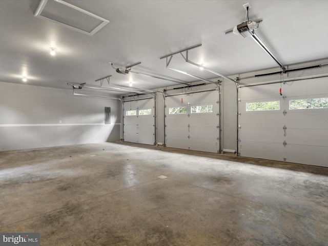 garage featuring electric panel and a garage door opener