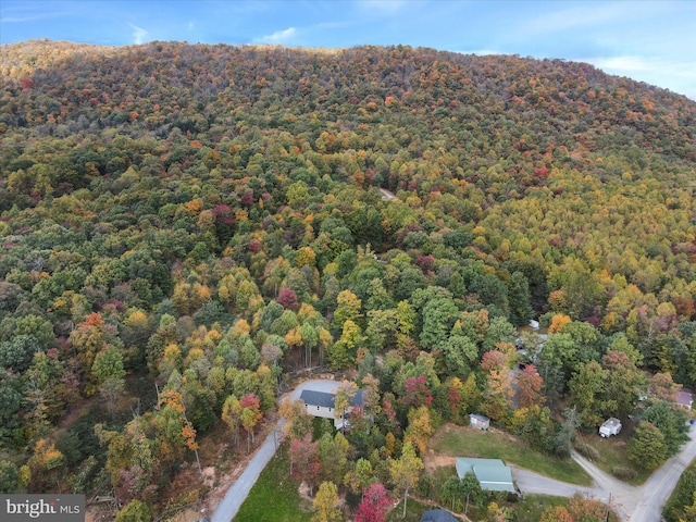 birds eye view of property featuring a wooded view