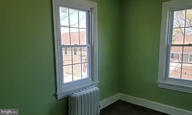 interior space with radiator heating unit and a healthy amount of sunlight