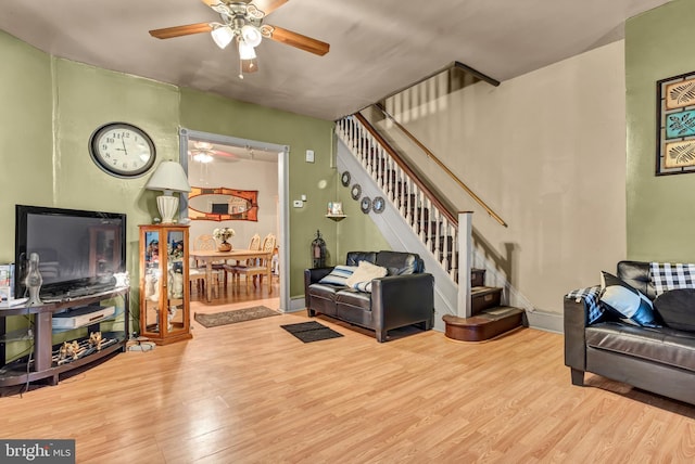 living room with ceiling fan and light wood-type flooring