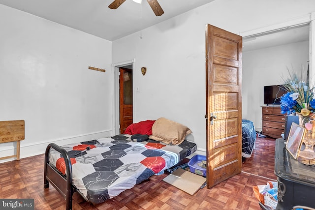 bedroom with parquet floors and ceiling fan