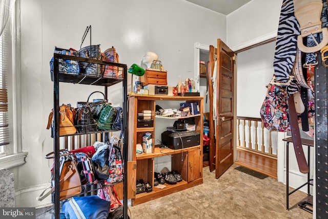 walk in closet with light tile patterned floors