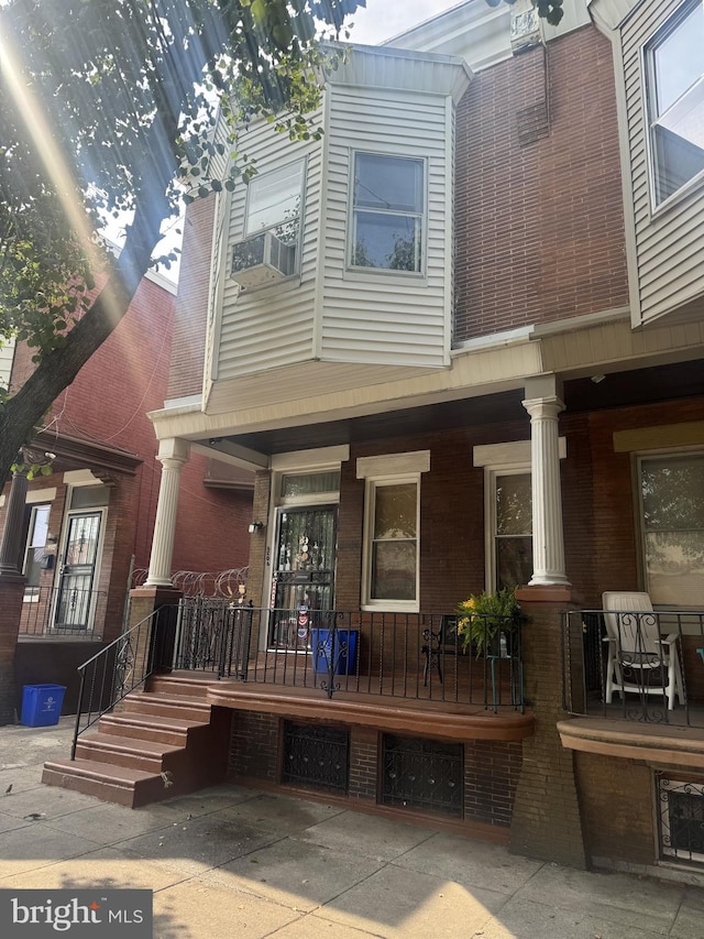 view of property featuring cooling unit and covered porch