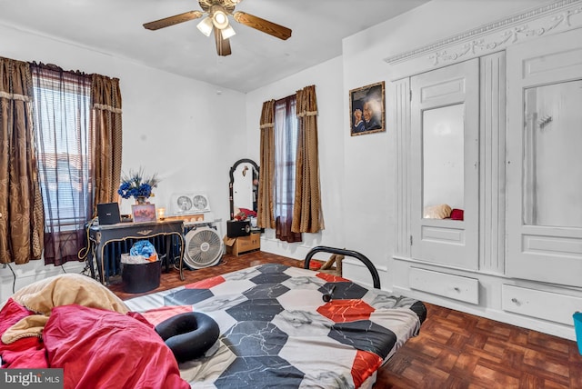 bedroom featuring ceiling fan and parquet flooring