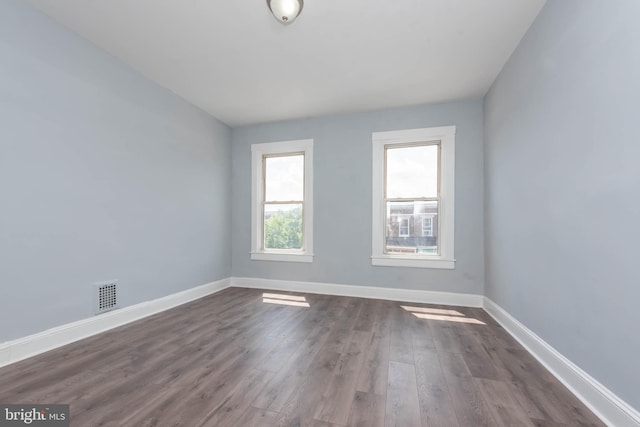 empty room featuring dark hardwood / wood-style flooring