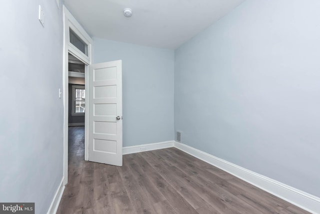 empty room featuring dark hardwood / wood-style flooring