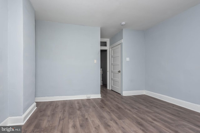 spare room with dark hardwood / wood-style flooring