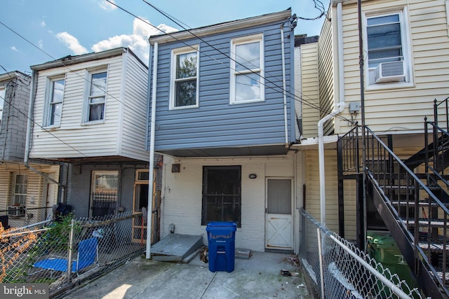 rear view of house featuring cooling unit