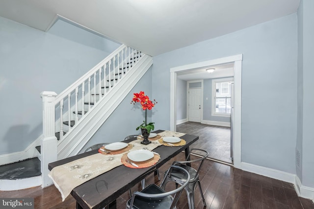 dining space featuring dark wood-type flooring