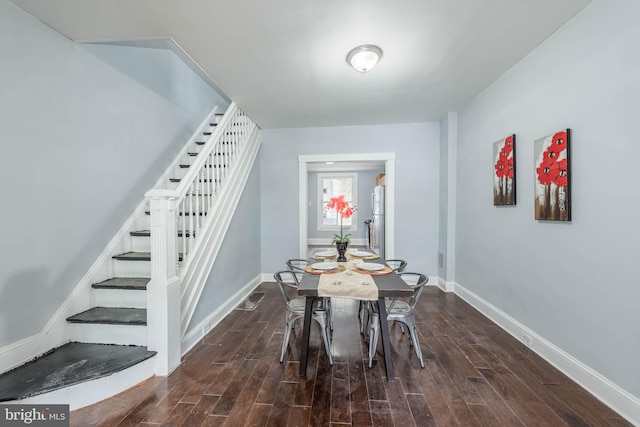 unfurnished dining area featuring dark wood-type flooring