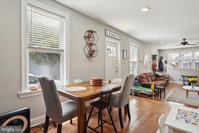 dining area with plenty of natural light, ceiling fan, and hardwood / wood-style flooring