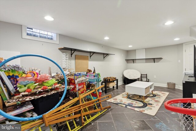 game room with dark tile patterned flooring