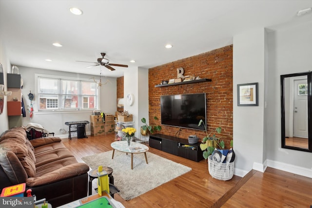 living room featuring hardwood / wood-style flooring and ceiling fan