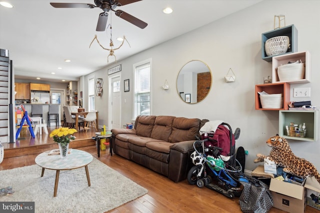 living room featuring hardwood / wood-style floors and ceiling fan