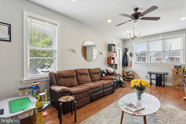 living room featuring light hardwood / wood-style floors and ceiling fan