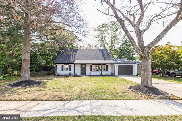 view of front of home with a garage and a front yard